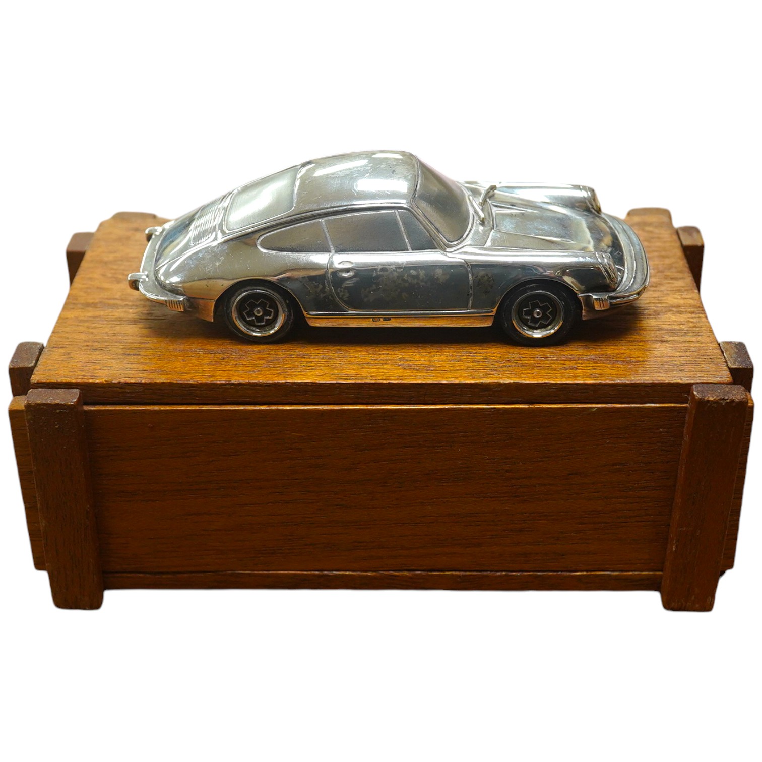 A 1:43 scale silver model of a Porsche 911, produced as a promotional model with details stamped to the base plate including; ‘Baujahr 1977, Porsche Design Produket, Sterling Silver 925’. Condition - fair to good, some m